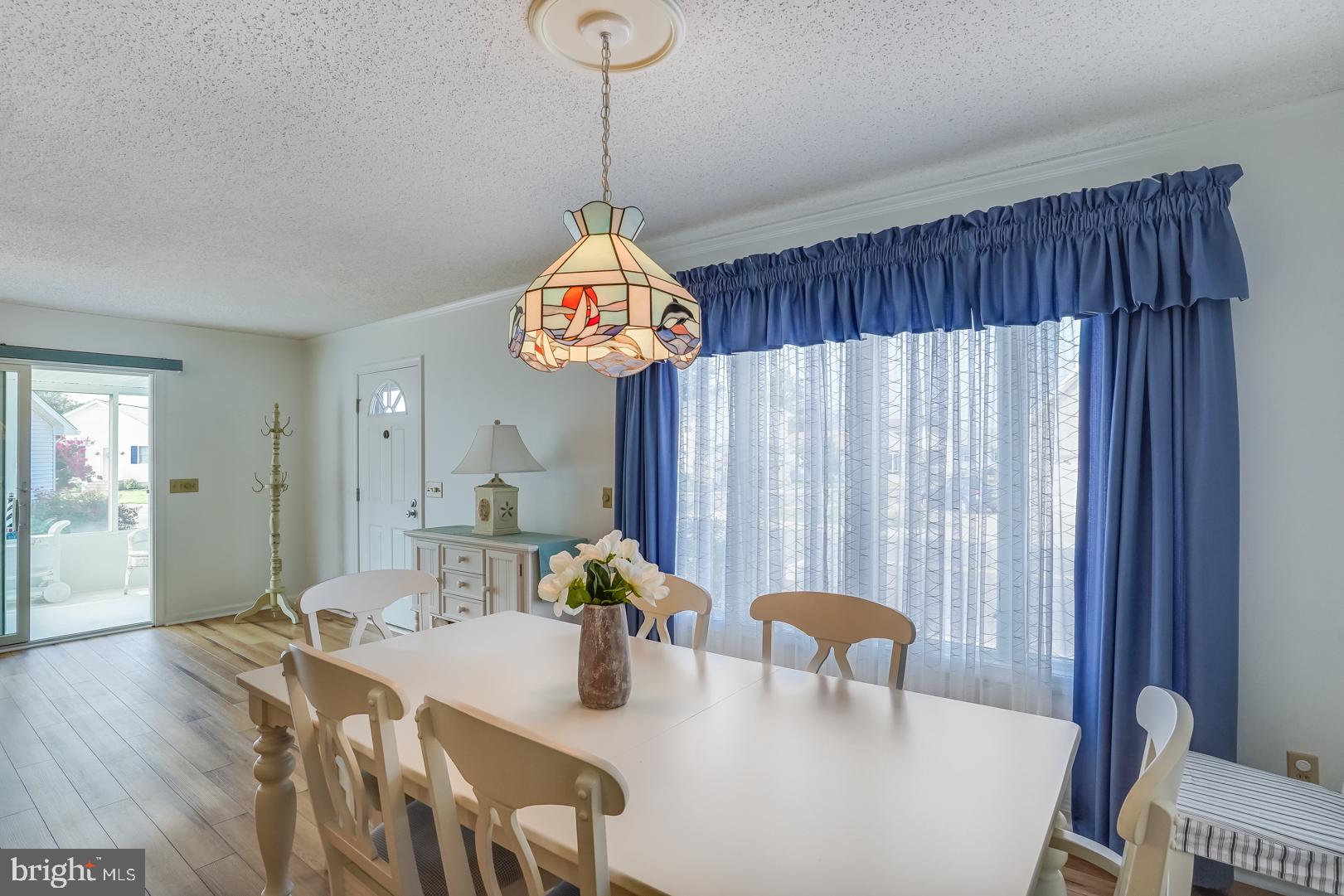13702 Sailing Road Ocean City, MD 21842 - Photo 7 of 32 a view of a dining room with furniture and chandelier