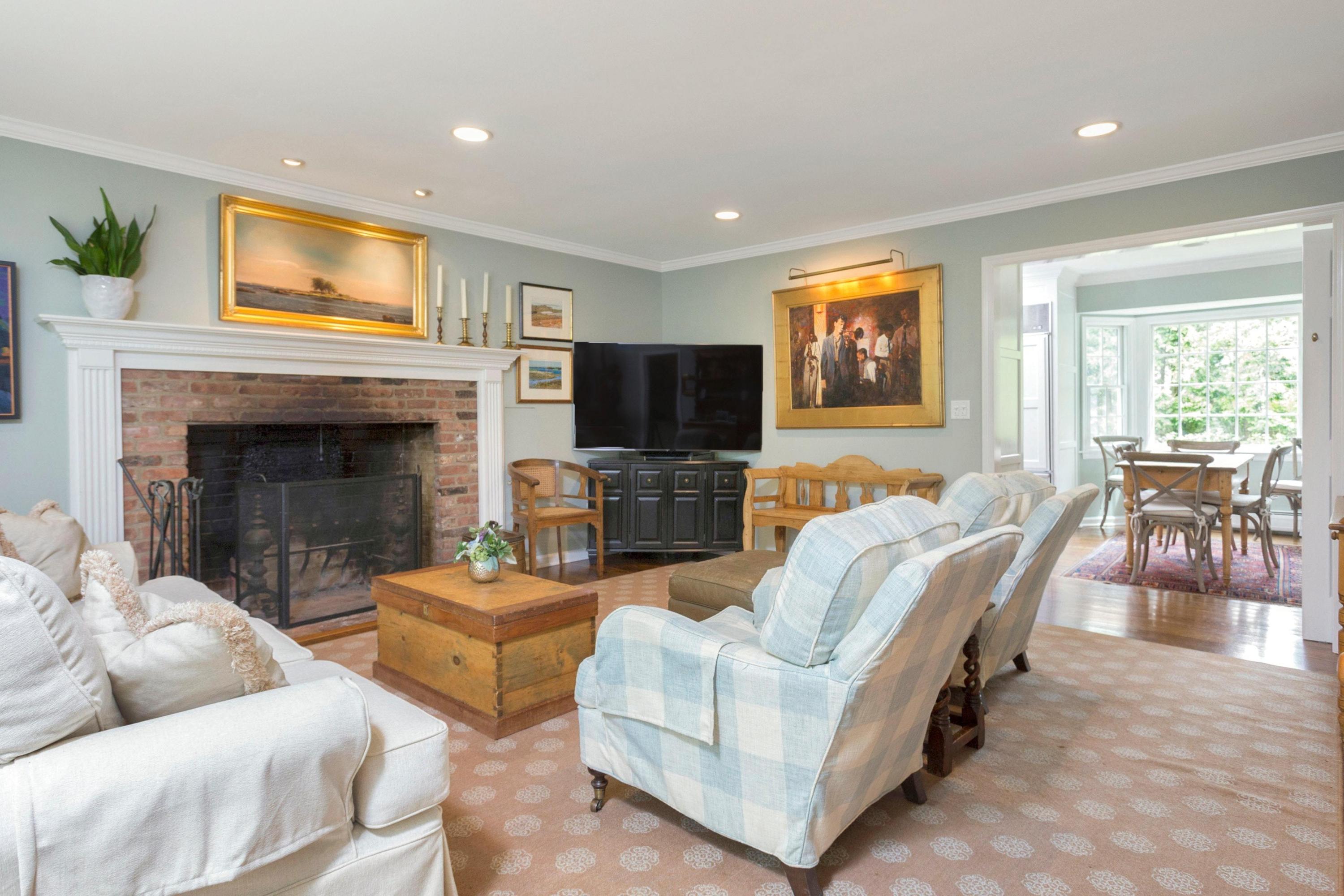 350 Middlesex Road Darien, CT 06820 - Photo 12 of 23 a living room with furniture flat screen tv and a fireplace