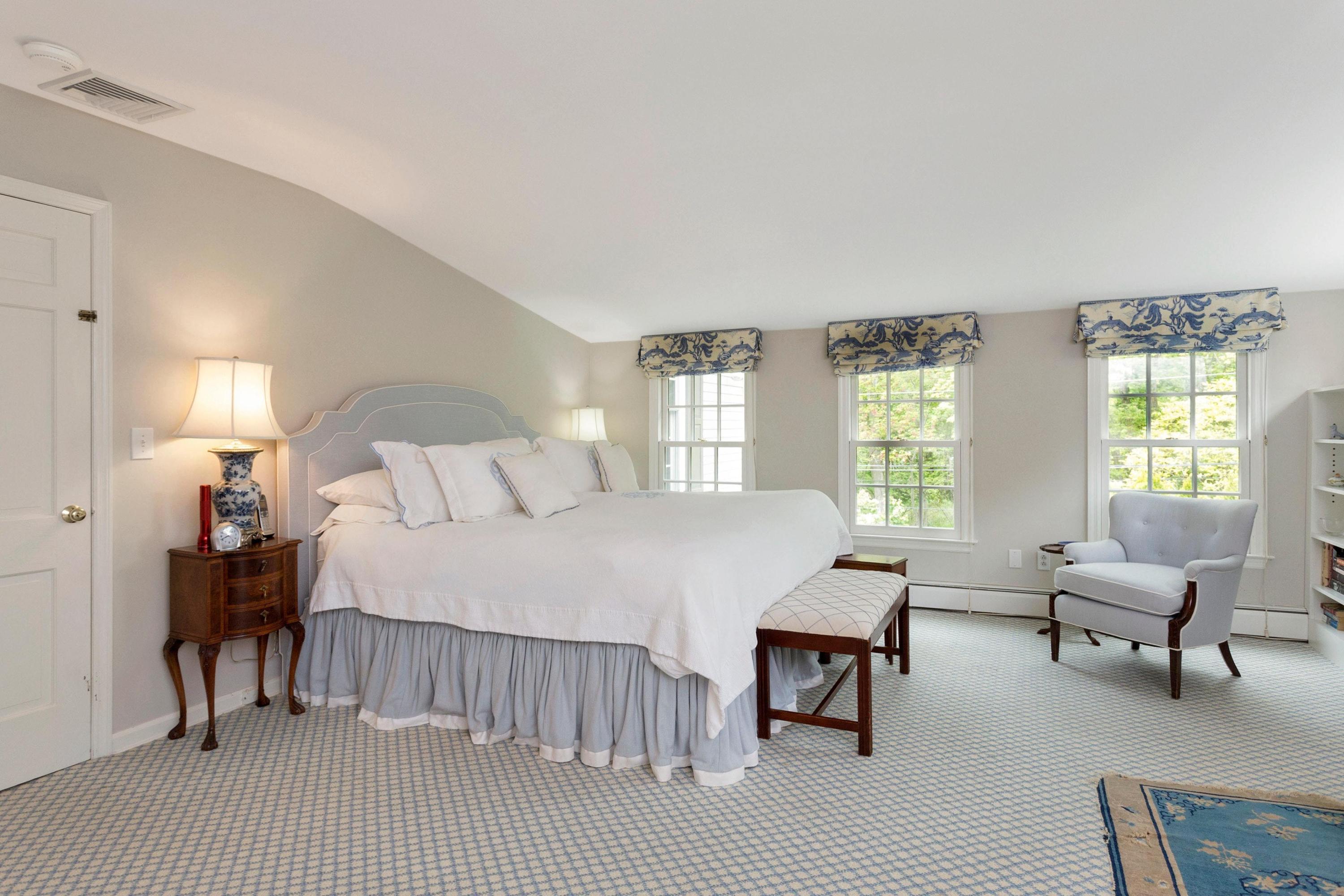 350 Middlesex Road Darien, CT 06820 - Photo 16 of 23 a bedroom with a bed and a chandelier