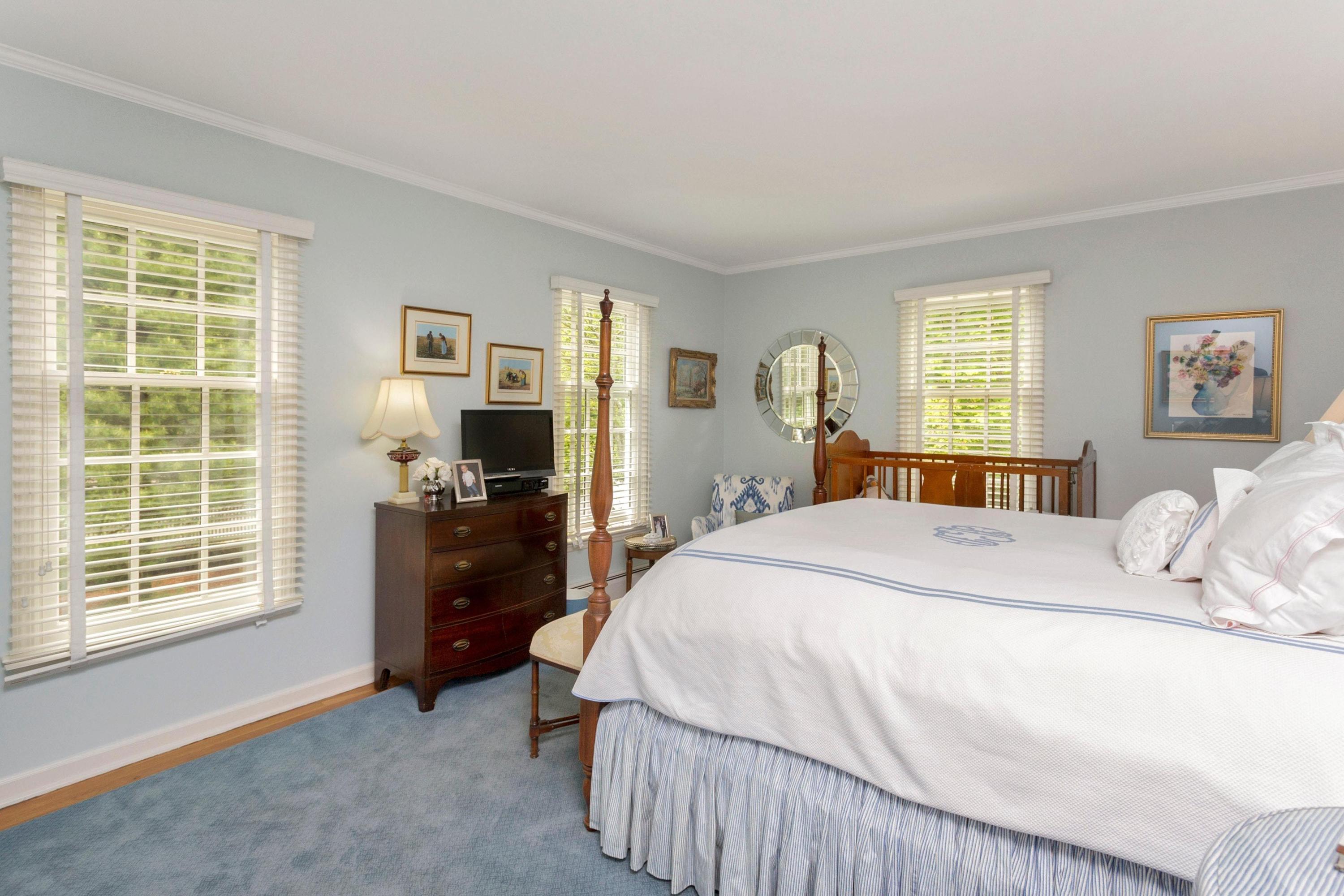 350 Middlesex Road Darien, CT 06820 - Photo 18 of 23 a bedroom with a bed and wooden floor