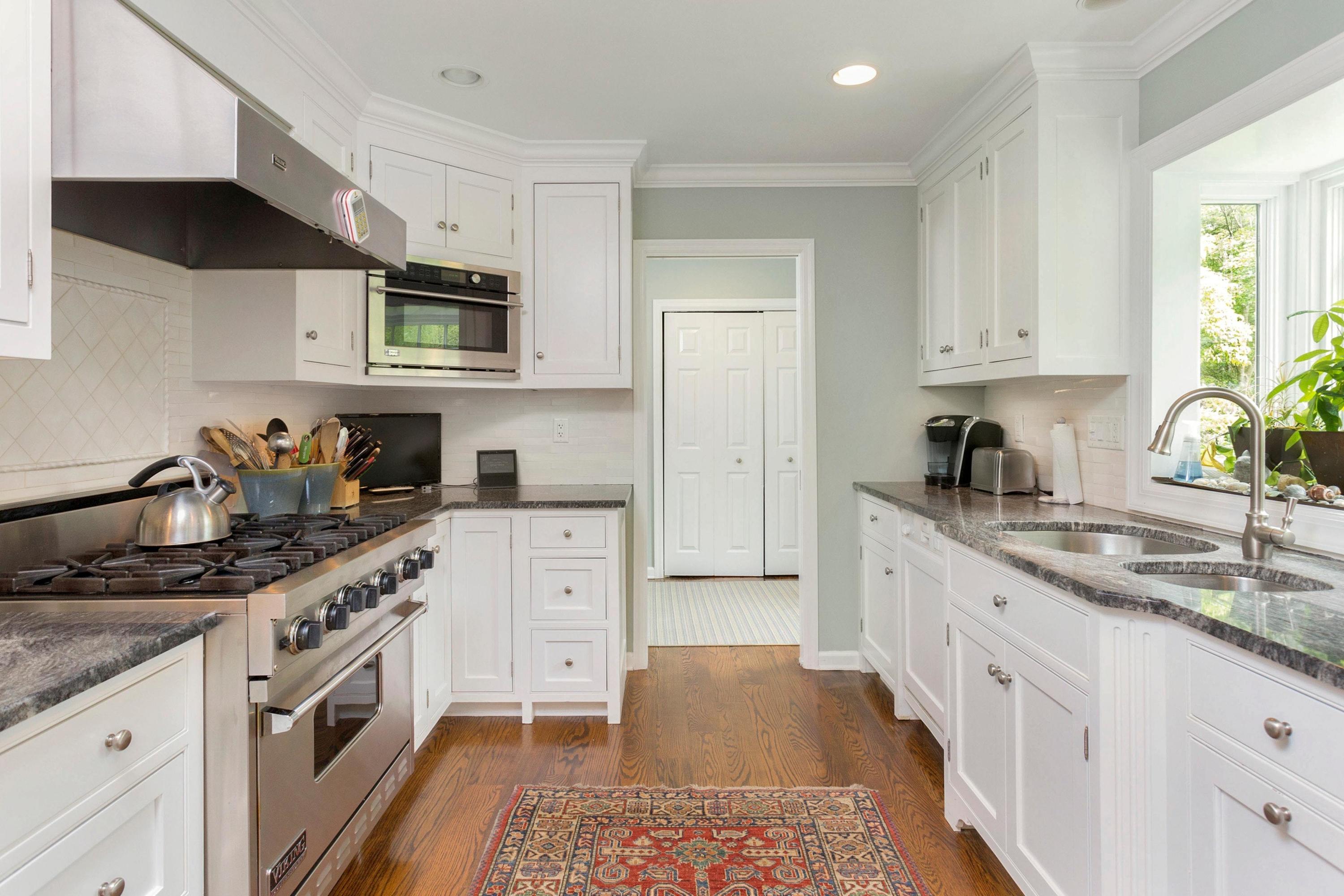 350 Middlesex Road Darien, CT 06820 - Photo 9 of 23 a kitchen with stainless steel appliances granite countertop white cabinets sink and stove