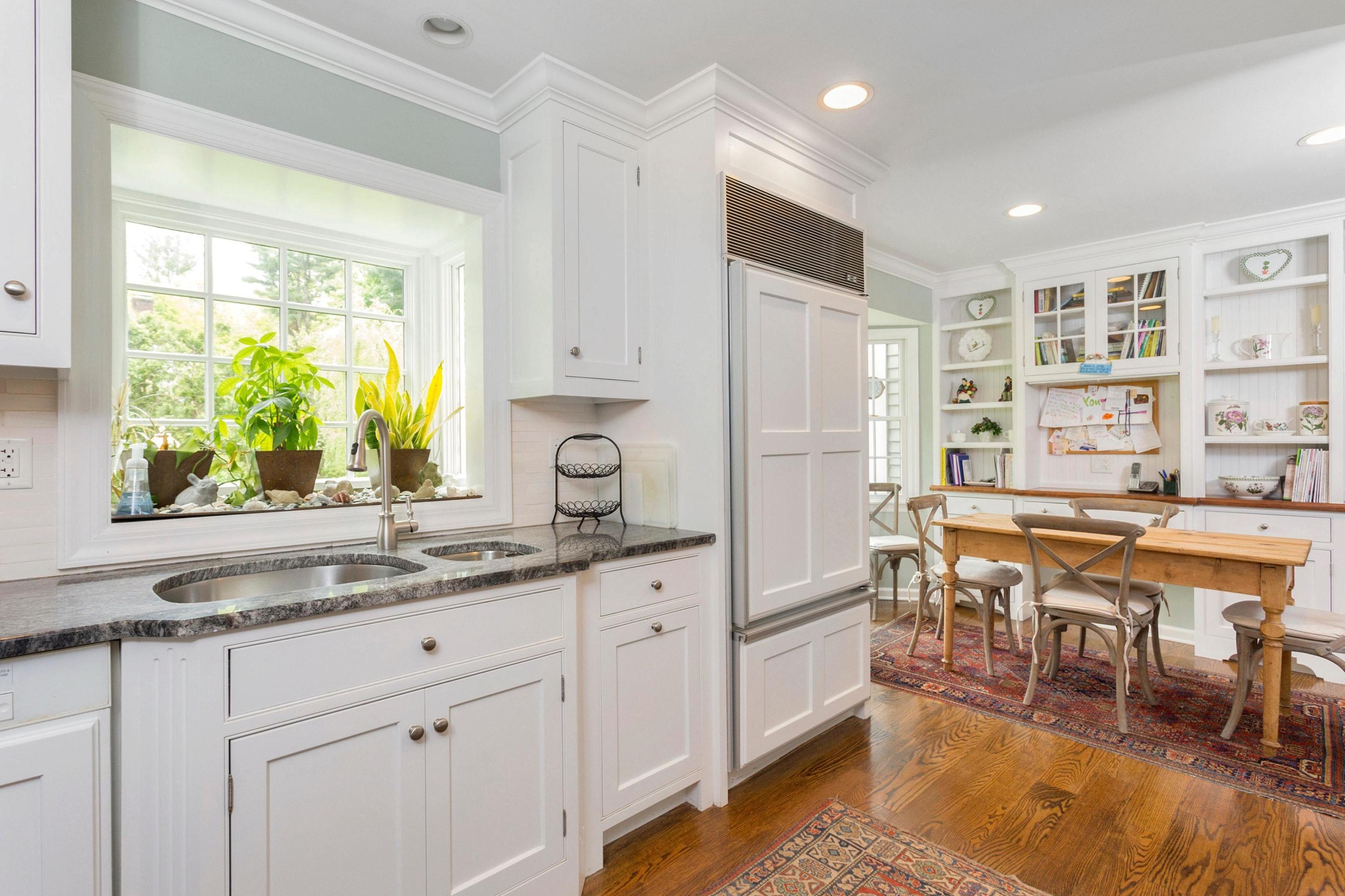 350 Middlesex Road Darien, CT 06820 - Photo 10 of 23 a kitchen with stainless steel appliances granite countertop a stove a sink dishwasher and white cabinets with wooden floor