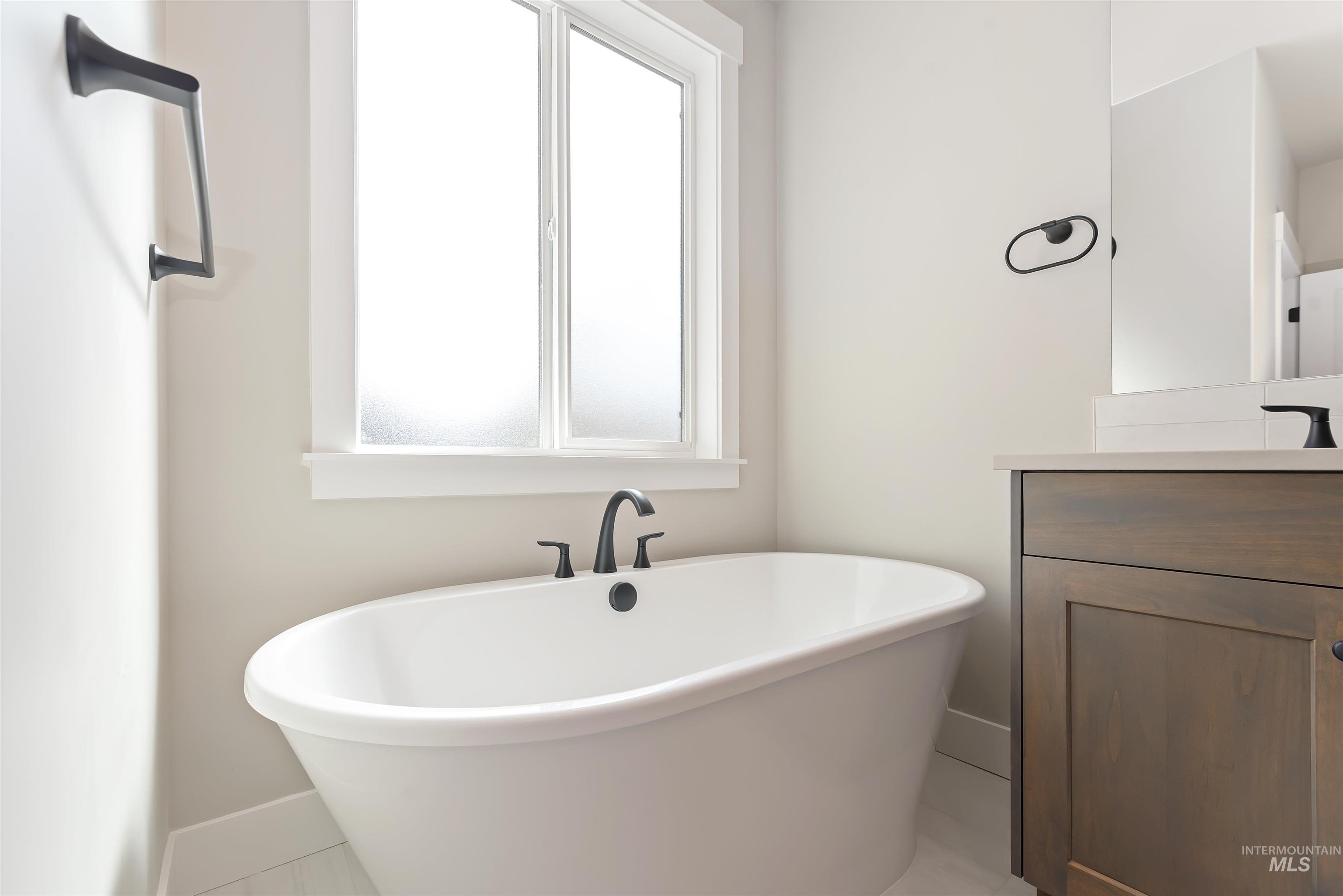 7616 Brown Way Eagle, ID 83714 - Photo 6 of 21 Full bathroom with vanity, a soaking tub, and healthy amount of natural light