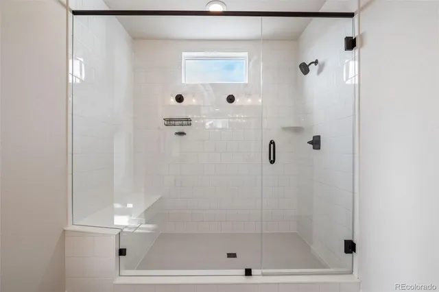 a bathroom with a granite countertop sink a toilet and a mirror