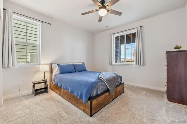 a living room with furniture and flowers