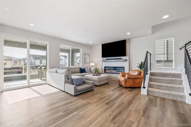 a living room with fireplace furniture and a flat screen tv