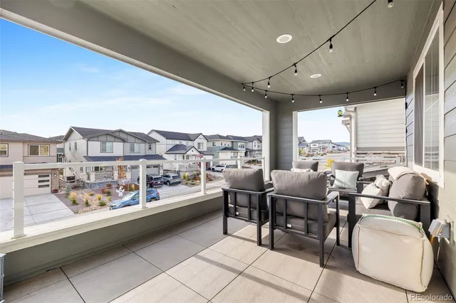 a living room with furniture a large window and a table