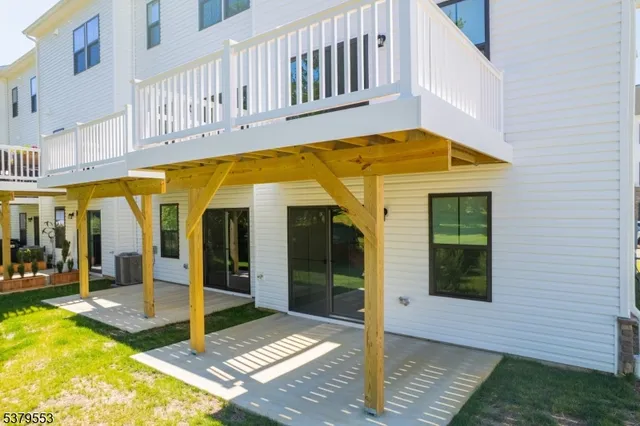 a view of a big room with wooden floor and windows