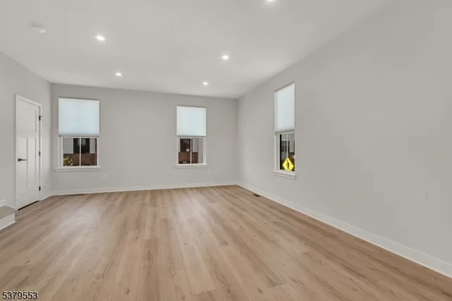 a view of a room with wooden floor