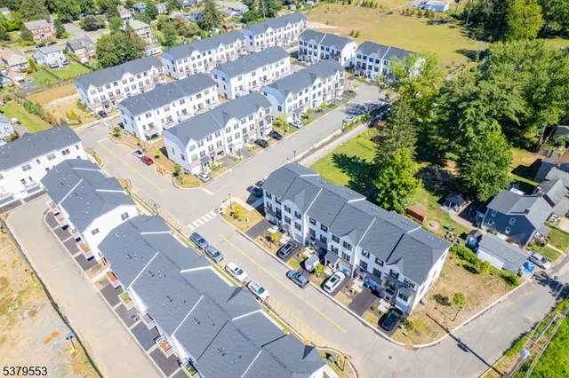 an aerial view of a house with pool and garden