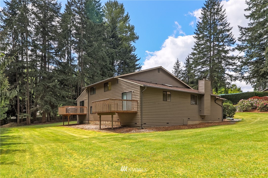 17213 Gravenstein Road Bothell, WA 98012 - Photo 4 of 14 a view of a house with a backyard