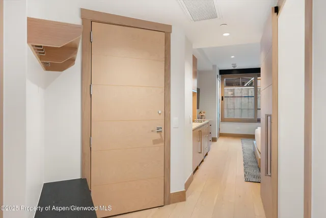 a view of a hallway with wooden shelves