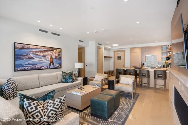 a living room with furniture kitchen view and a table