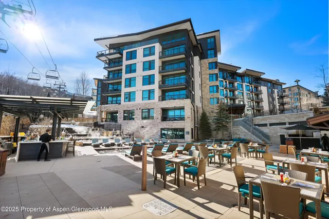 a view of a swimming pool with outdoor seating