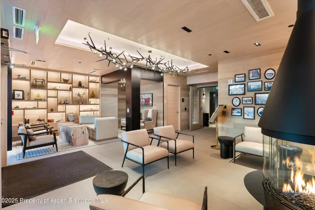 a spacious bedroom with a bed a couch and large window