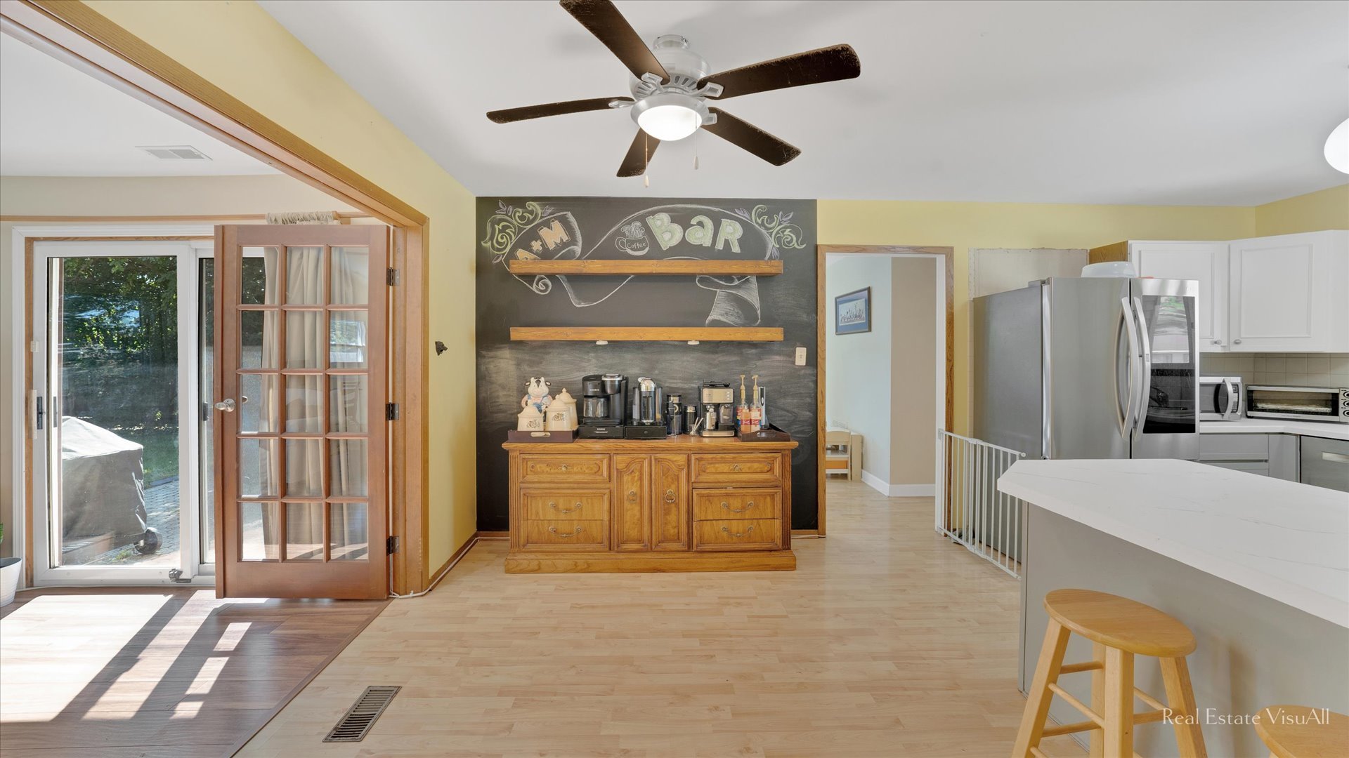 1385 Cooper Road Hoffman Estates, IL 60169 - Photo 11 of 26 a large kitchen with stainless steel appliances granite countertop a refrigerator a stove and a sink with wooden floor