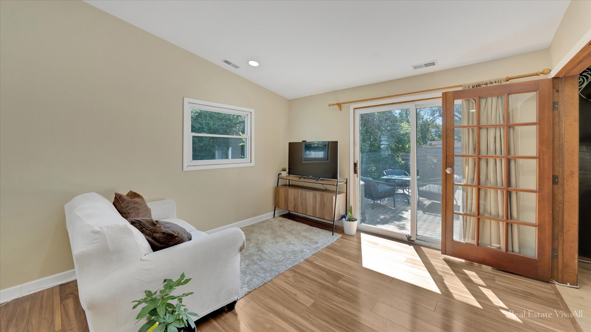 1385 Cooper Road Hoffman Estates, IL 60169 - Photo 13 of 26 a living room with furniture a flat screen tv and a large window