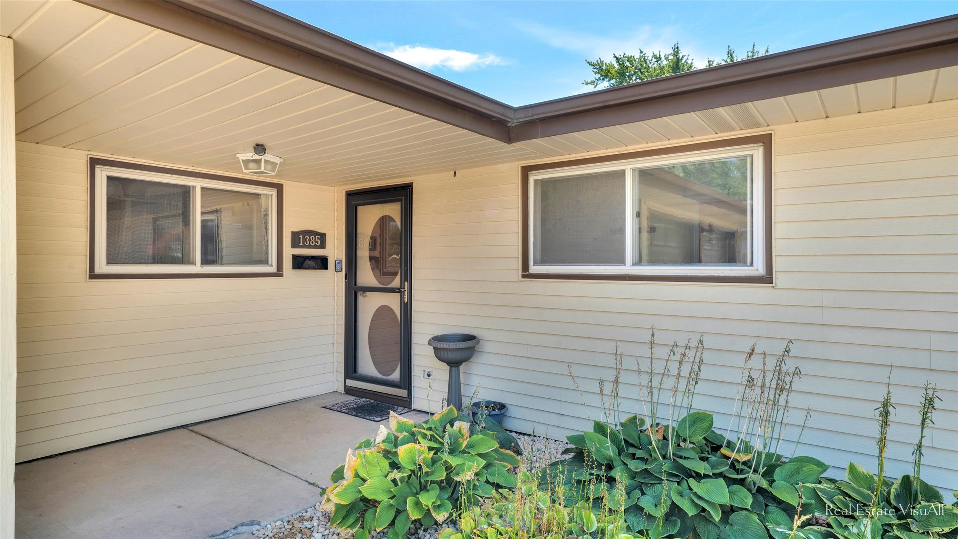 1385 Cooper Road Hoffman Estates, IL 60169 - Photo 3 of 26 a front view of a house with garden
