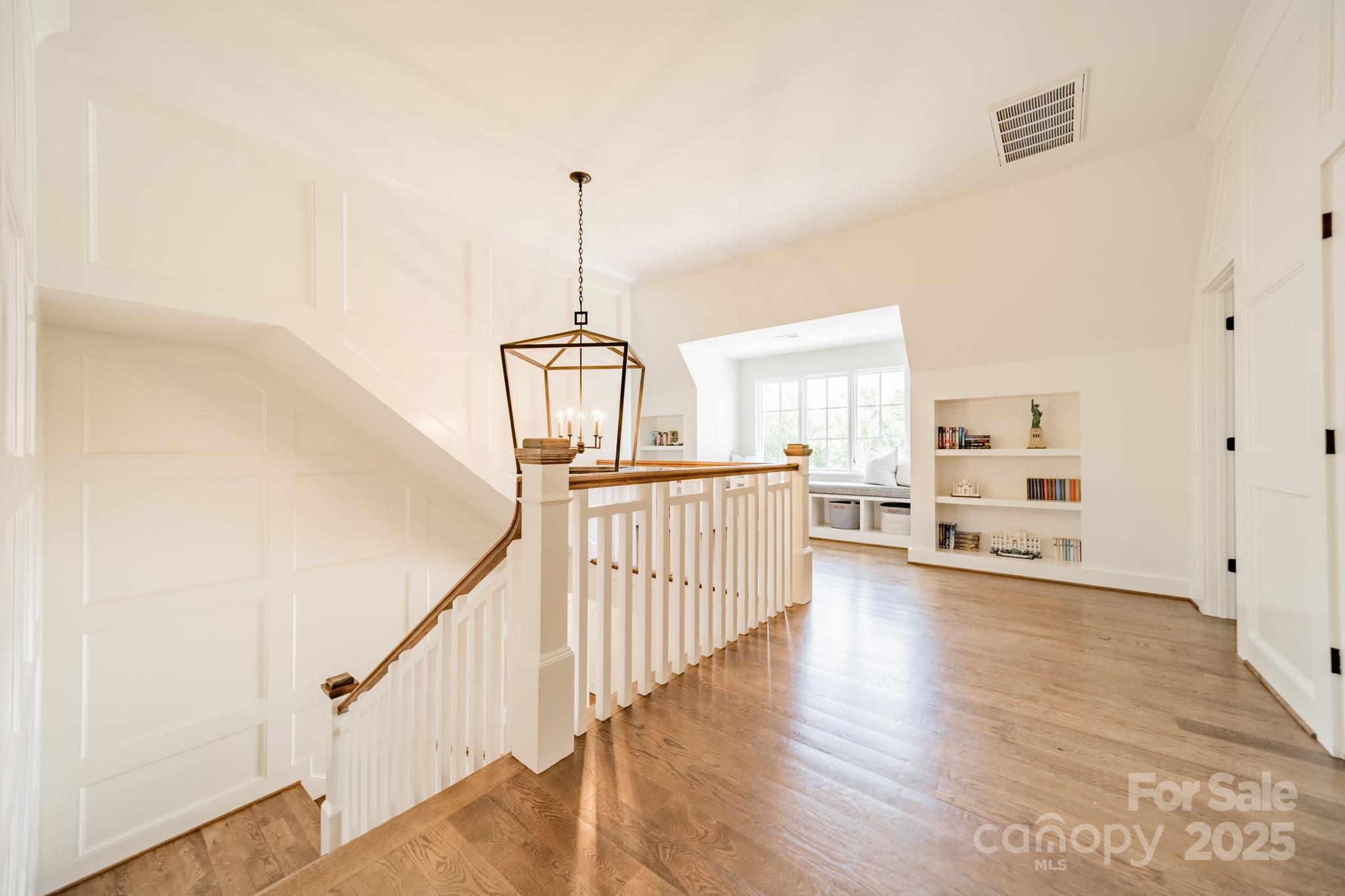 431 Bramble Way Fort Mill, SC 29708 - Photo 29 of 48 a view of a hallway with wooden floor stairs and a livingroom view