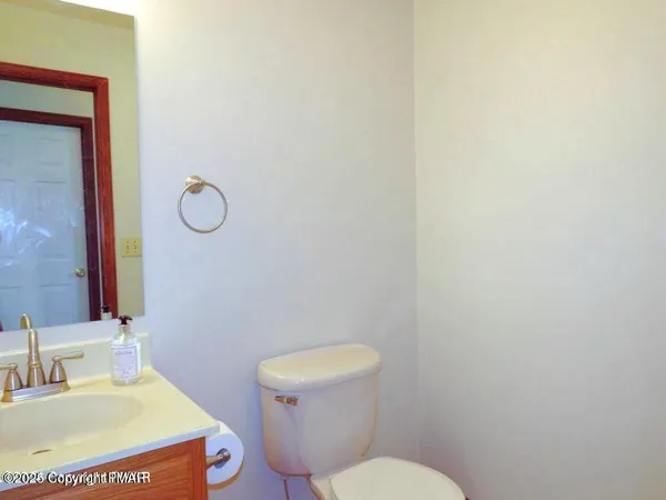 a bathroom with a toilet sink and mirror