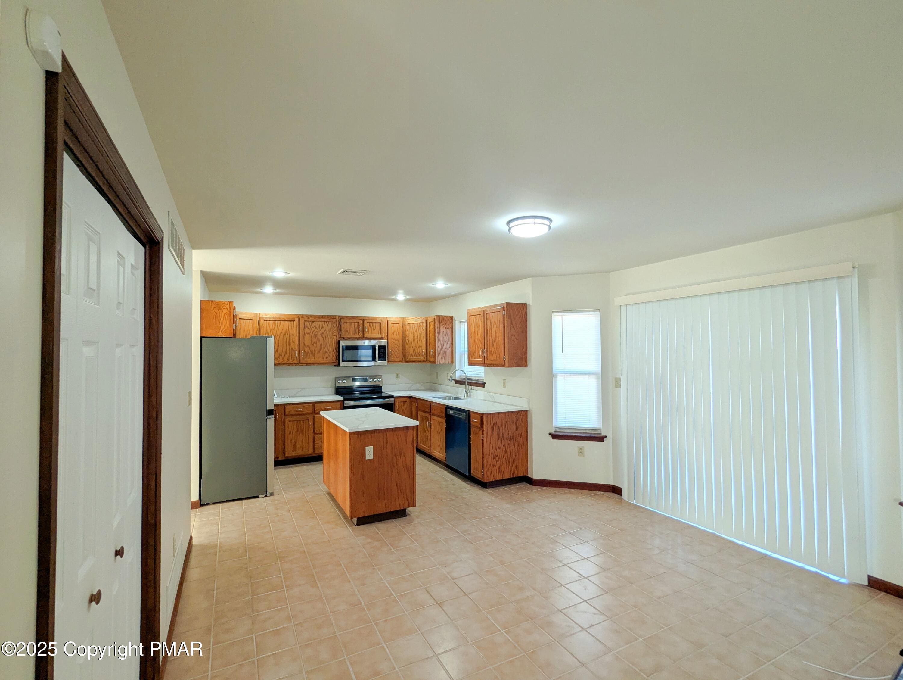 1603 Rachel Road Stroudsburg, PA 18360 - Photo 8 of 33 a room with kitchen island a sink wooden floor and view living room