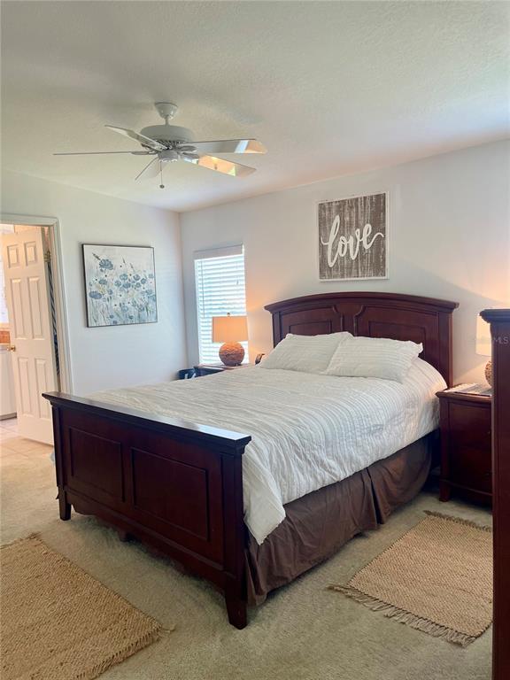 11200 Walsingham Road, Unit 139 Largo, FL 33778 - Photo 6 of 13 a bedroom with a large bed and a chandelier