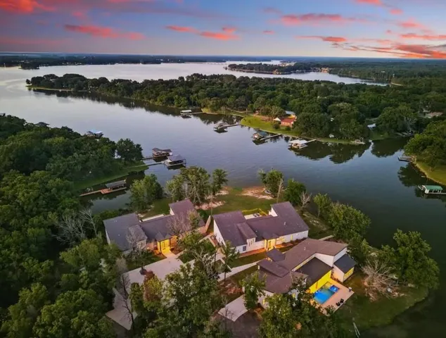 an aerial view of house with yard and ocean view