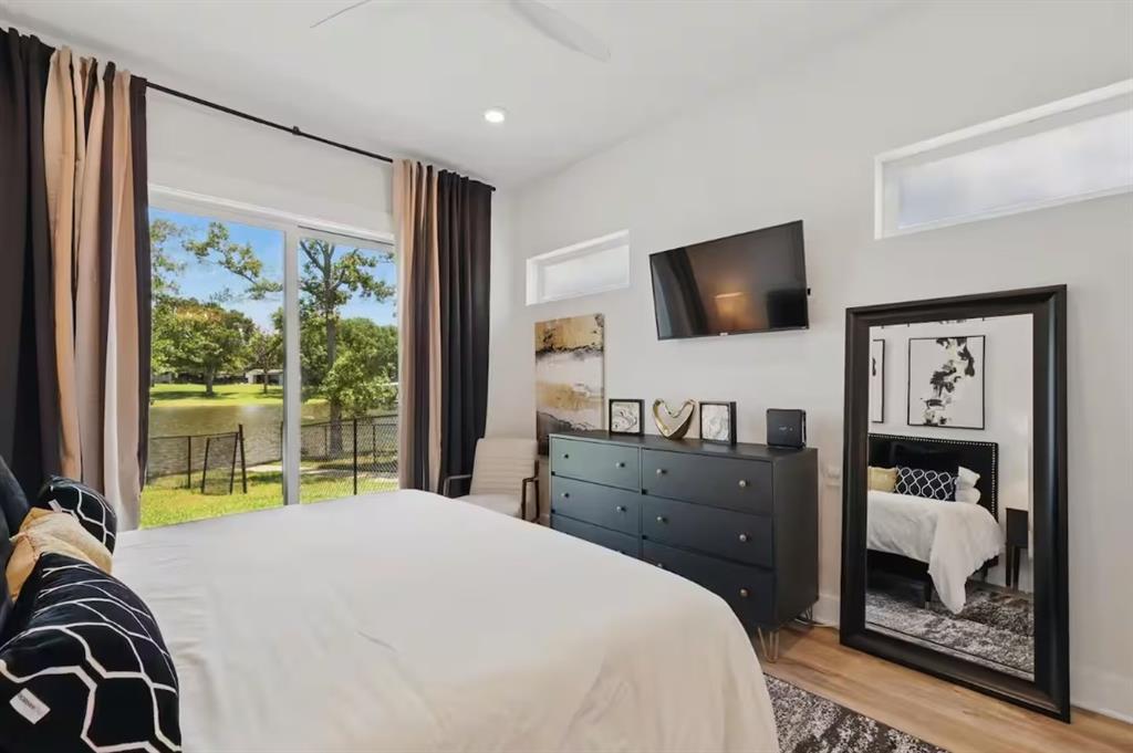 2752 Briarwood Harbor Road Malakoff, TX 75148 - Photo 25 of 37 a bedroom with a bed and a flat tv screen on dresser