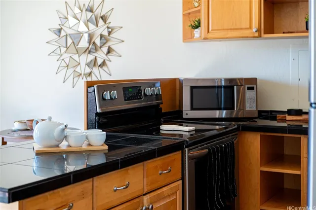 a kitchen with stainless steel appliances a stove and a microwave