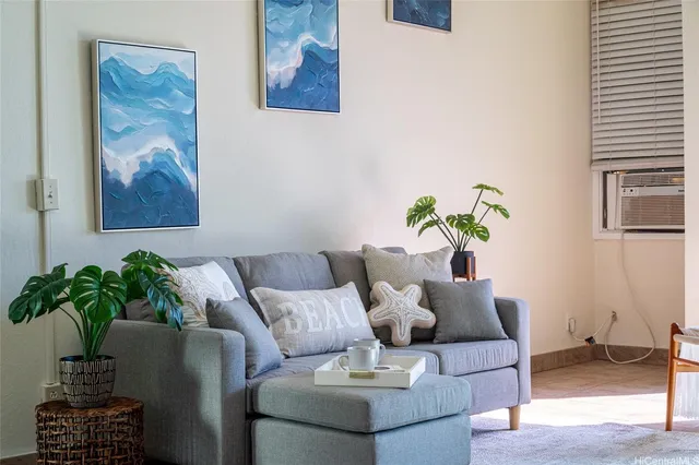 a living room with furniture and flowers