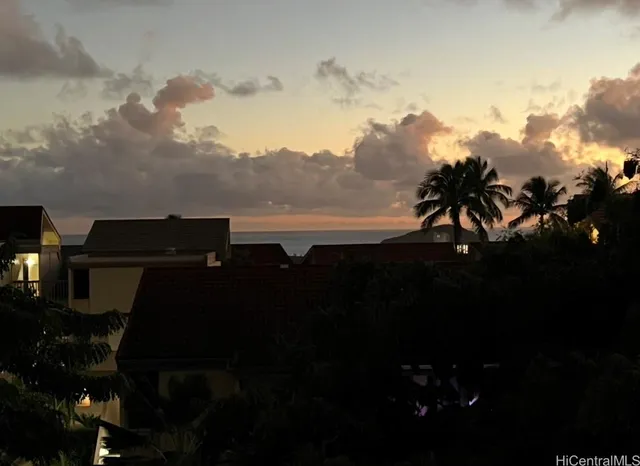 a view of a patio with table and chairs with wooden fence