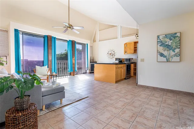a living room with furniture and a potted plant