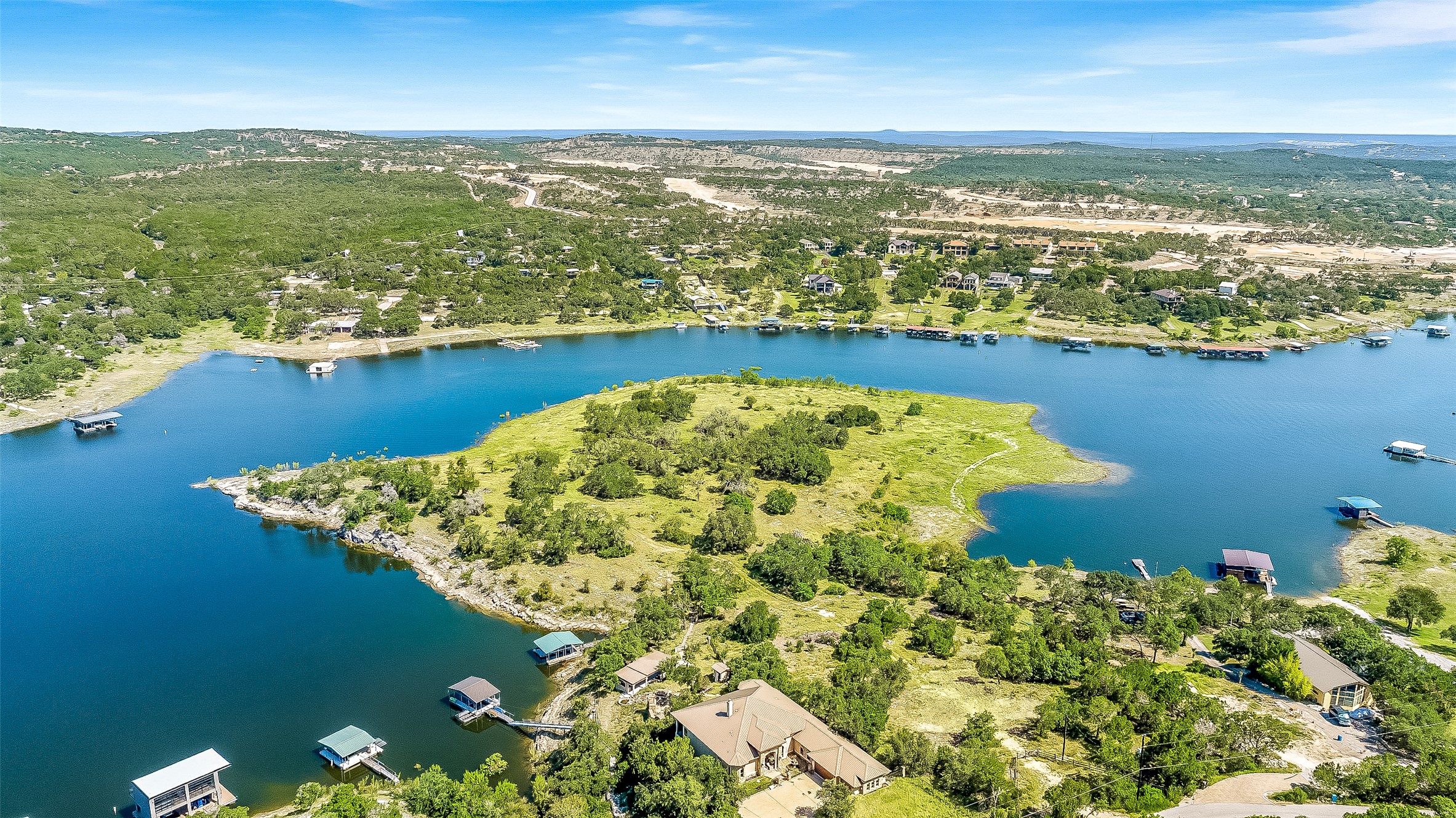 19813 Lakehurst Loop Spicewood, TX 78669 - Photo 11 of 22 an aerial view of water body with boats and trees in the background