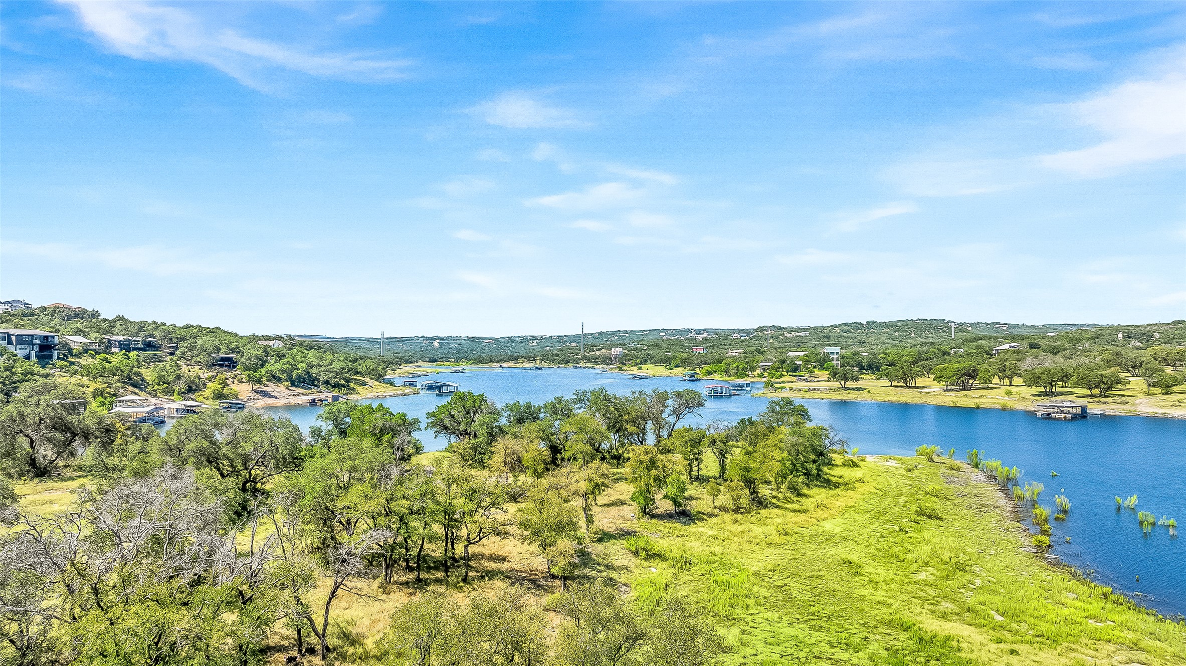 19813 Lakehurst Loop Spicewood, TX 78669 - Photo 20 of 22 a view of a lake with houses in the back