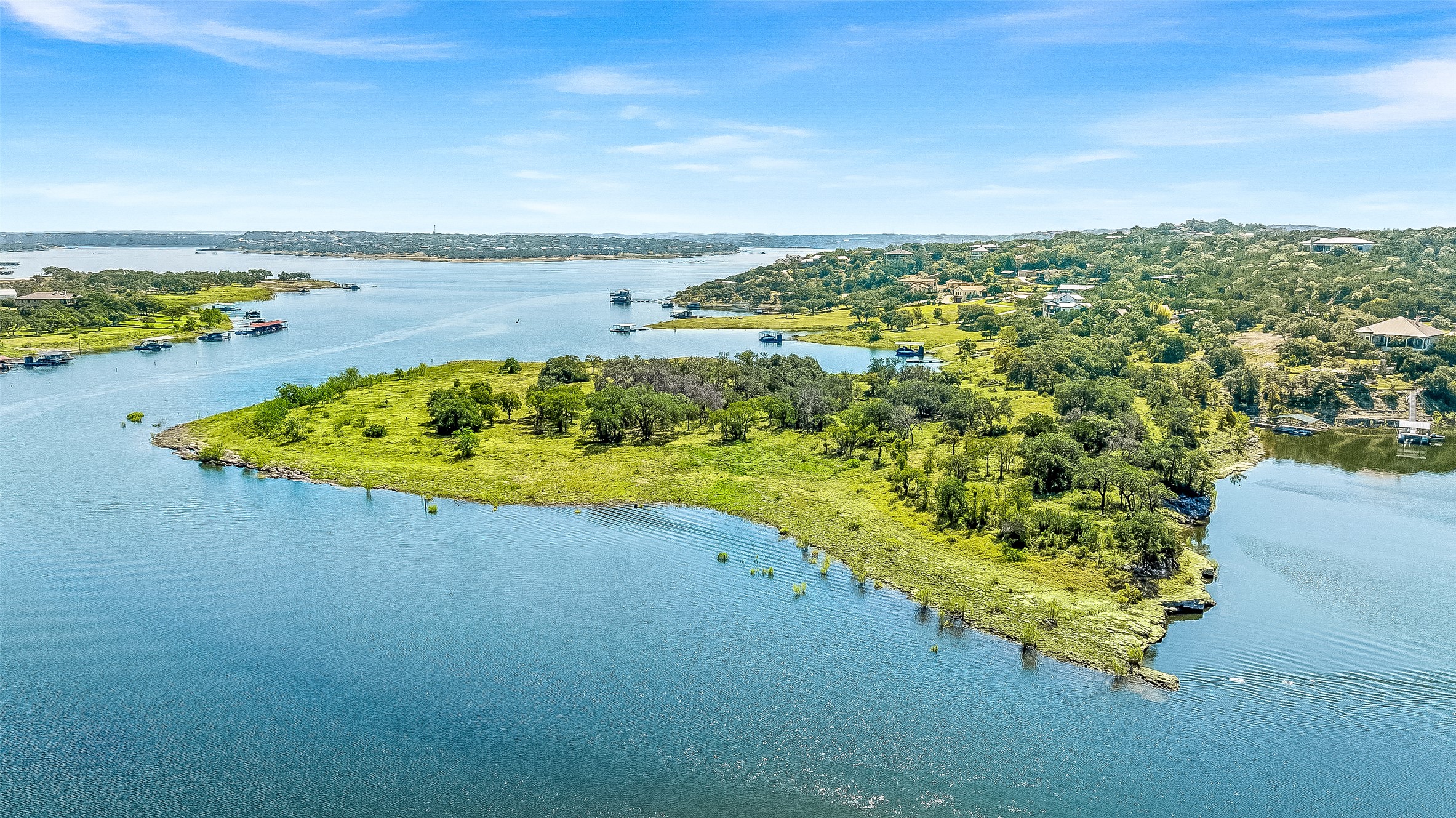 19813 Lakehurst Loop Spicewood, TX 78669 - Photo 9 of 22 a view of a lake with a beach