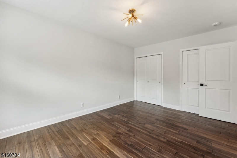 31 Upper Mountain Avenue, Unit 4 Montclair, NJ 07042 - Photo 13 of 22 a view of an empty room with wooden floor