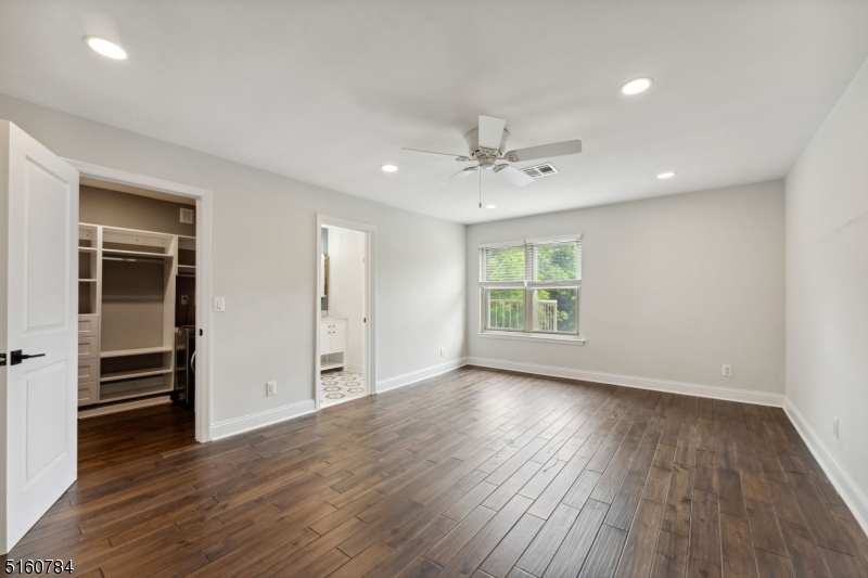 31 Upper Mountain Avenue, Unit 4 Montclair, NJ 07042 - Photo 14 of 22 an empty room with wooden floor closet and windows