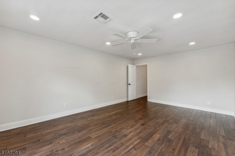 31 Upper Mountain Avenue, Unit 4 Montclair, NJ 07042 - Photo 17 of 22 an empty room with wooden floor and ceiling fan