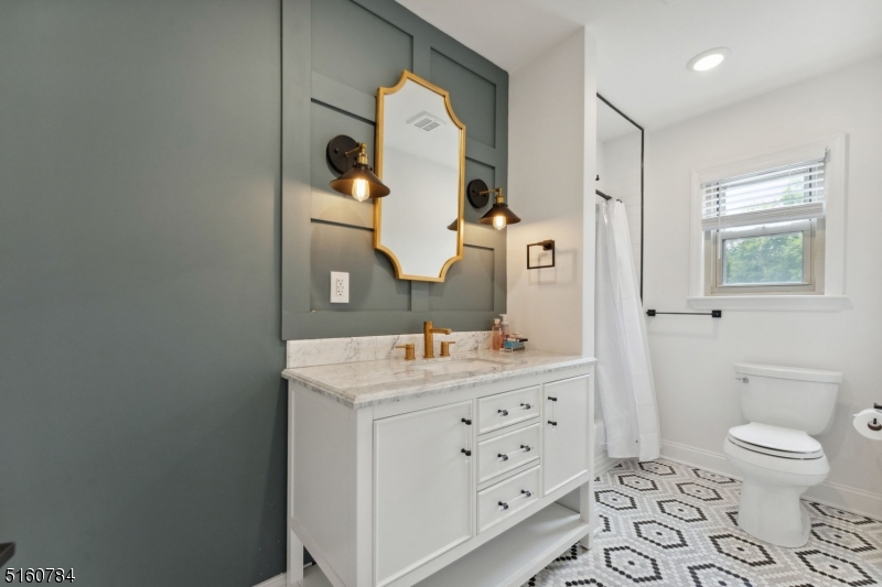 31 Upper Mountain Avenue, Unit 4 Montclair, NJ 07042 - Photo 18 of 22 a bathroom with a toilet a sink and mirror