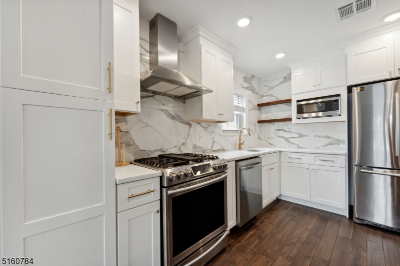 31 Upper Mountain Avenue, Unit 4 Montclair, NJ 07042 - Photo 5 of 22 a kitchen with stainless steel appliances granite countertop a stove and a refrigerator