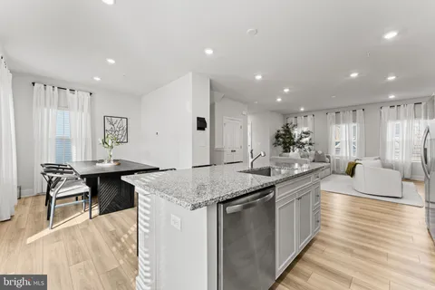 a kitchen with center island table and chairs