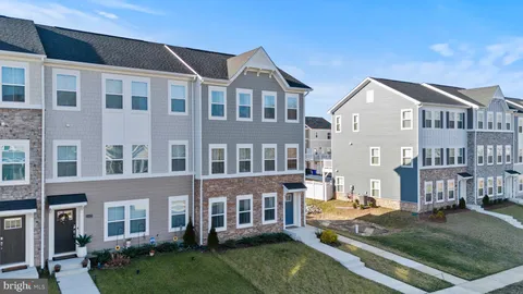 a front view of a residential apartment building with a yard