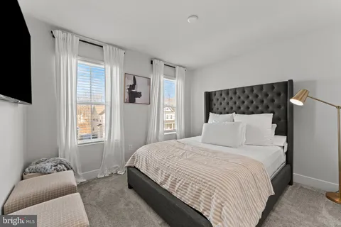 a bedroom with a bed and flat screen tv