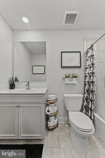 a bathroom with a sink a toilet and a shower