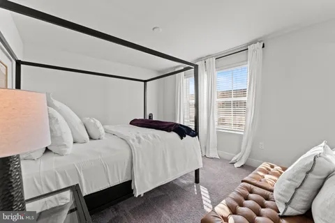 a bedroom with bed and a window