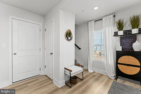 a view of a room with wooden floor and windows