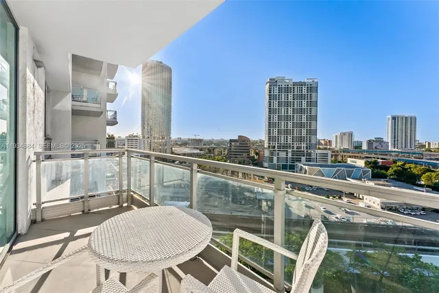 a balcony with table and chairs