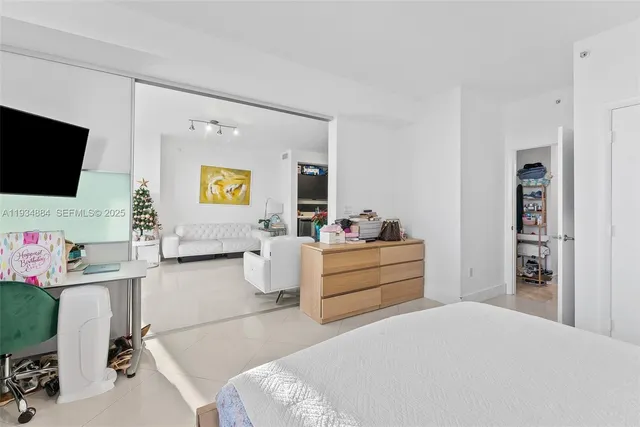 a bed room with furniture and flat screen tv