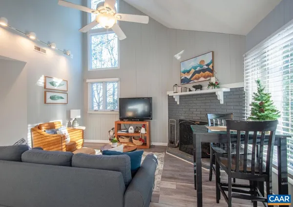 a living room with furniture a flat screen tv and a fireplace