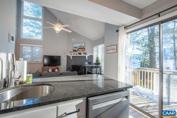 a kitchen with stainless steel appliances granite countertop a stove top oven a refrigerator a sink and a stove